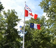 Acadian flag flying at Government House